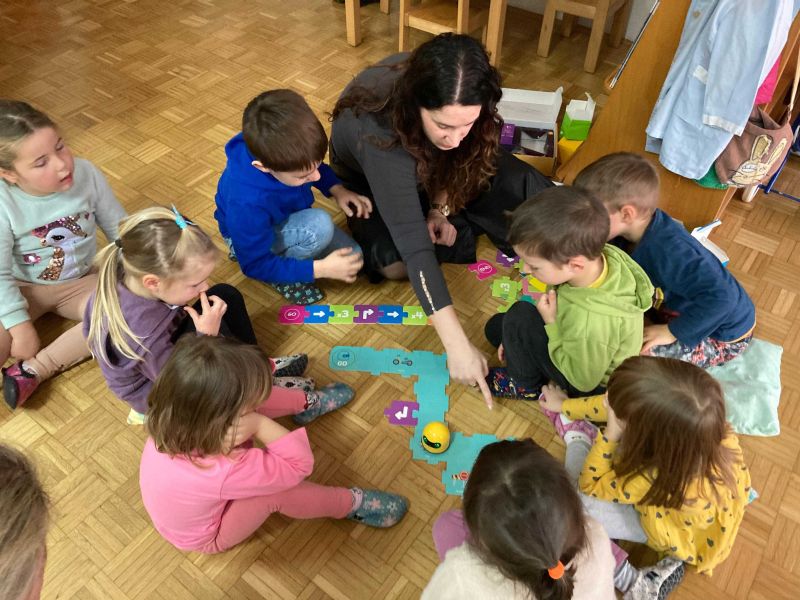Children exploring a non-screen robot during a hands-on STEM activity