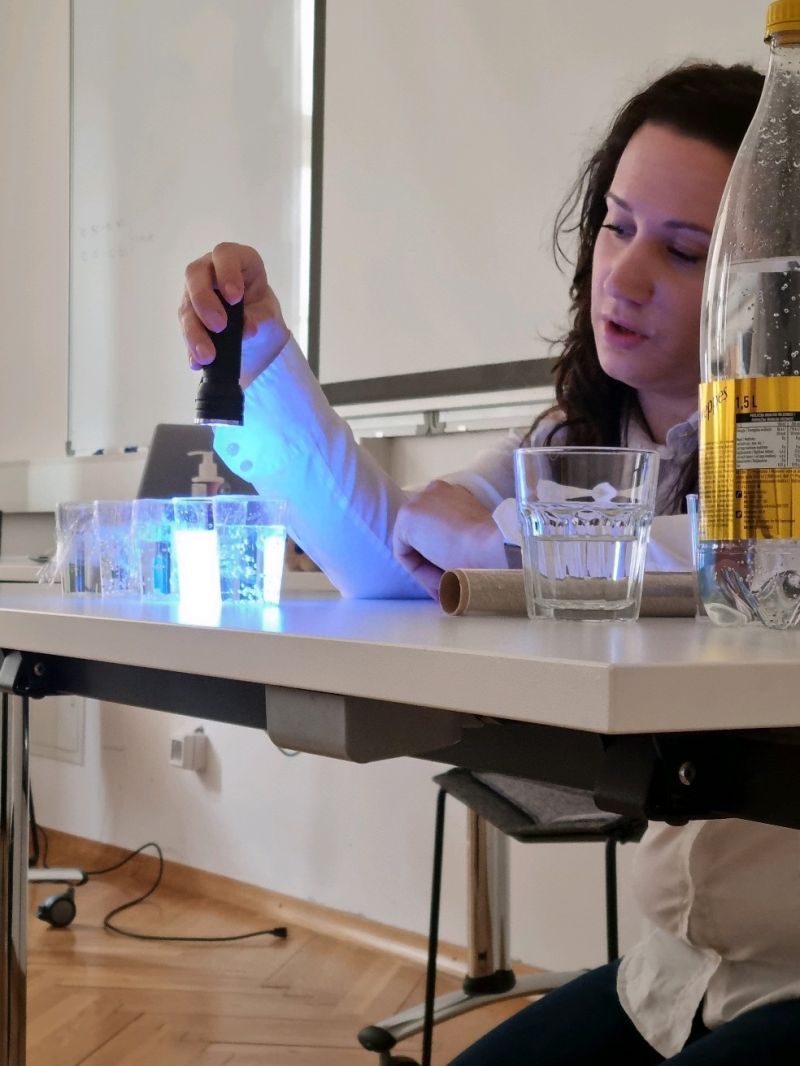GoINNO facilitator demonstrating a hands-on science activity with UV light